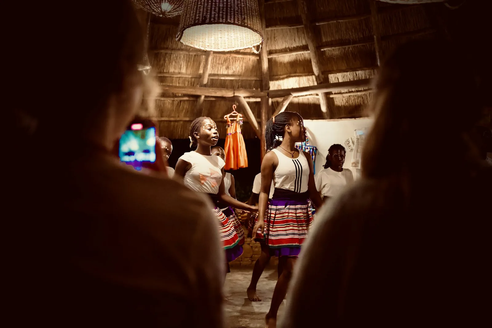 Young dancers performing while a community audience watches in Uganda